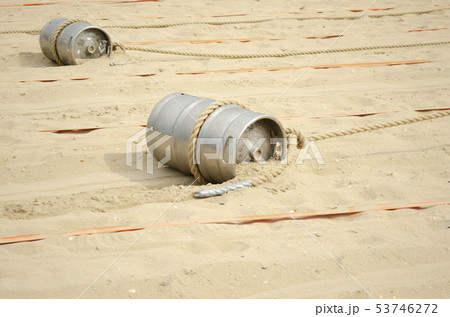 Sports competition with a barrel and a rope on the 53746272