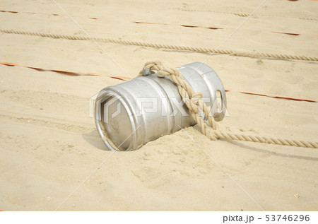 Sports competition with a barrel and a rope  53746296