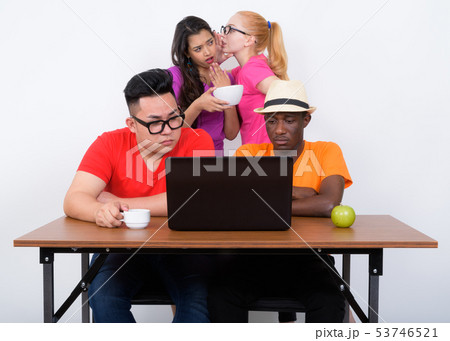 Studio shot of diverse group of multi ethnic friends using lapto 53746521