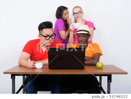 Studio shot of diverse group of multi ethnic friends using lapto 53746522