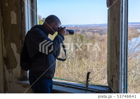 The photographer takes pictures from the window 53746641