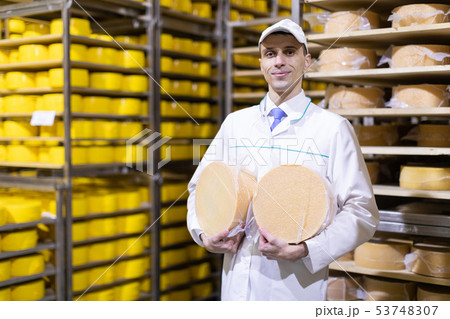 Portrait of inspector standing in production department of dairy factory and take view of redy Portrait of inspector standing in production department of dairy factory and take view of redy 53748307