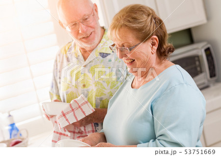 Senior Adult Couple Having Fun Washing Dishes 53751669