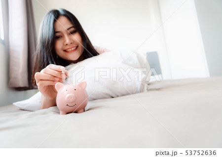 Close-Up Woman Hand is Putting a Money Coin  53752636