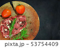 Raw meat steak on wooden board with dark  backgrou 53754409