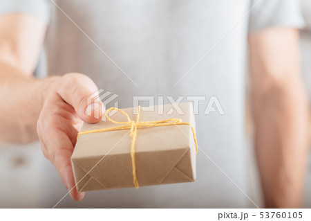 delivery service man giving rustic style package 53760105