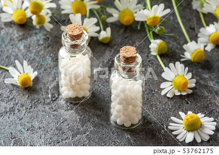 Bottles of homeopathic pills with chamomile Bottles of homeopathic pills with chamomile 53762175