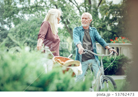 Positive bearded man walking with his bicycle 53762473
