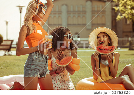 写真素材: Energetic three girls having fun durin