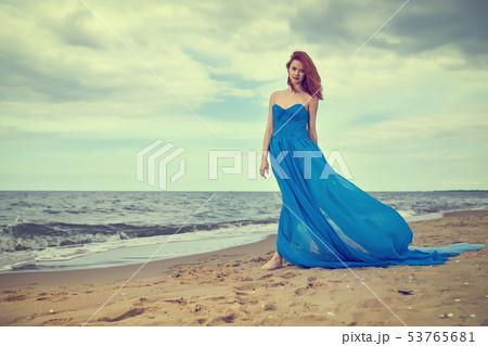 Woman in a blue dress on the beach. Summer woman Woman in a blue dress on the beach. Summer woman 53765681