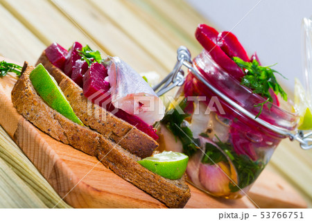 Pickled whiting in homemade marinade with beets Pickled whiting in homemade marinade with beets 53766751
