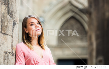 City portrait of woman near old wall 53768686