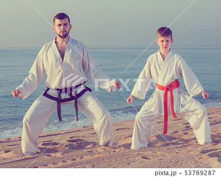 Man and boy practicing karate 53769287