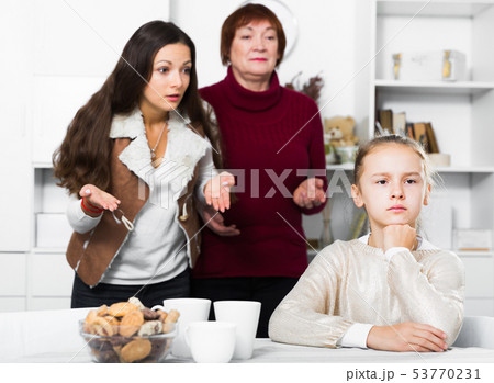 Upset girl scolded by mother and grandma Upset girl scolded by mother and grandma 53770231