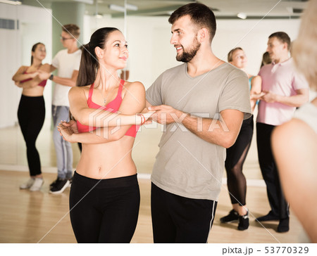 Group of young adults dancing salsa in club Group of young adults dancing salsa in club 53770329