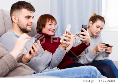 Happy family with phone at home 53770664