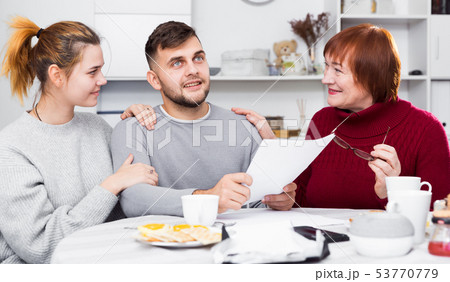 Happy family reading mail together 53770779