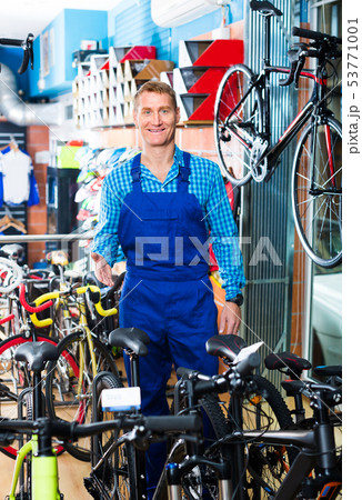 man in uniform working in bicycle shop . 53771001