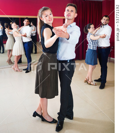People learning to dance waltz in dancing class 53771192