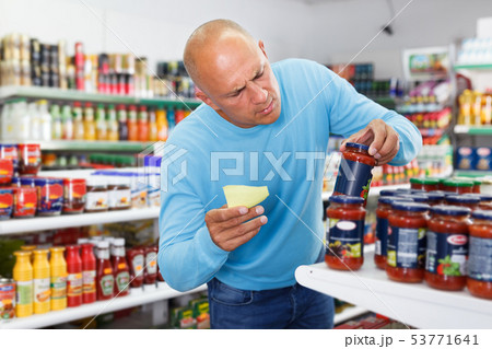 Man buying food in supermarket Man buying food in supermarket 53771641