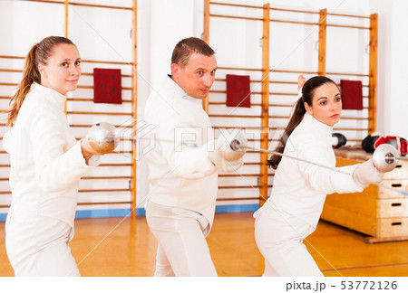 Man and women fencers practicing movements together 53772126