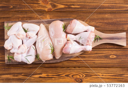 Raw chicken meat on wooden background Raw chicken meat on wooden background 53772163