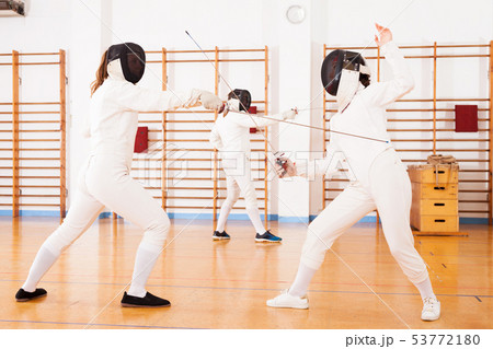 female athletes practicing movements at fencing battle 53772180