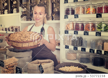 Girl seller is demonstraiting walnut in bag Girl seller is demonstraiting walnut in bag 53772238