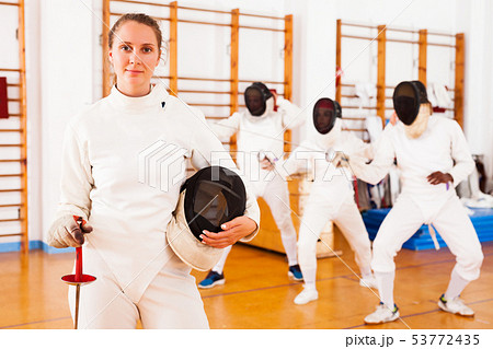 female in uniform standing at fencing room female in uniform standing at fencing room 53772435
