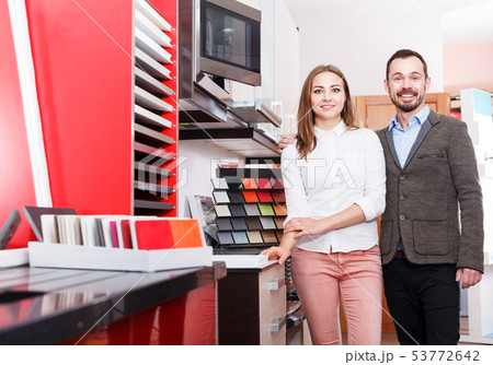 Family couple in kitchen furniture salon 53772642