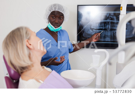 African american doctor man shows the patient an x-ray African american doctor man shows the patient an x-ray 53772830