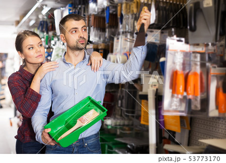 Couple choosing putty knife 53773170