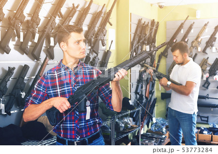 Friends choosing air-powered gun 53773284