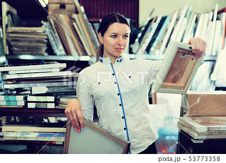 Woman buying wall picture 53773358