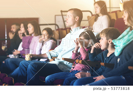 People enjoying film screening in cinema 53773818