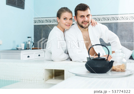 Couple drinking tea in spa center Couple drinking tea in spa center 53774322
