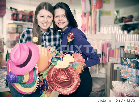 Girls in store of festival accessories Girls in store of festival accessories 53774375
