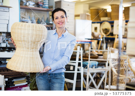 Female choosing straw pouf Female choosing straw pouf 53775375