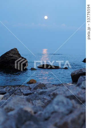 sea landscape at sunset with moon, stone coast and sea landscape at sunset with moon, stone coast and 53776594