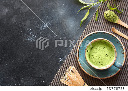 Organic green matcha tea on black table. Top view. 53776723