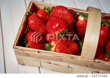 fresh juicy red strawberries in basket on white table fresh juicy red strawberries in basket on white table 53777104