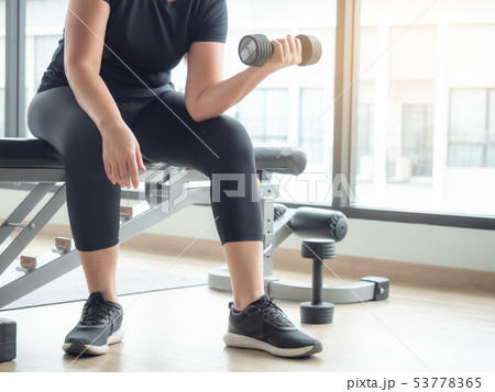 Plump woman start working out with dumbbell weight Plump woman start working out with dumbbell weight 53778365