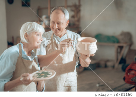 Half length of happy mature potters working in potter's studio Half length of happy mature potters working in potter's studio 53781160