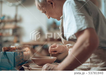 Close up of Caucasian craftsman working in potter's studio 53781940