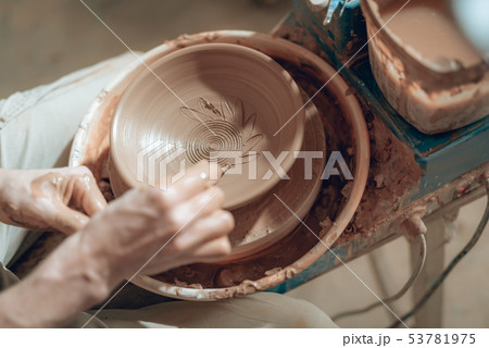 Close up of male arms with stick over ceramic plate 53781975
