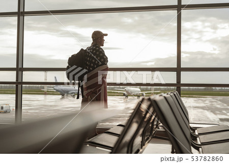 Low angle of American soldier in camouflage looking at window 53782860