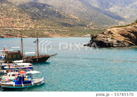 small fishing boats at pier in fishing village Bali with mountains at background in Crete, Greece small fishing boats at pier in fishing village Bali with mountains at background in Crete, Greece 53785570