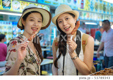 travelers eating fried sausage at fair market 53789343