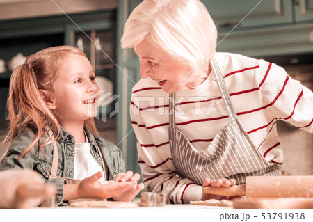 Pleased senior blonde looking at her granddaughter 53791938