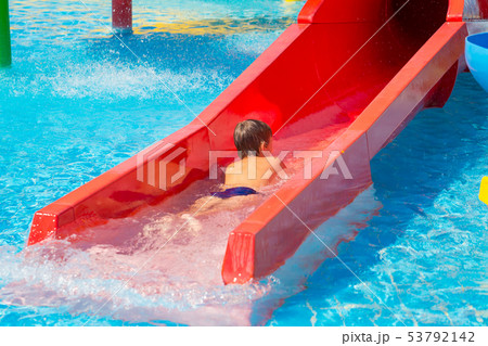 Happy cheerful caucasian boy on water slide at Happy cheerful caucasian boy on water slide at 53792142